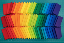 Load image into Gallery viewer, 101 fat quarter bundle laid out on cutting table, based on kona cotton bright 101 palette 
